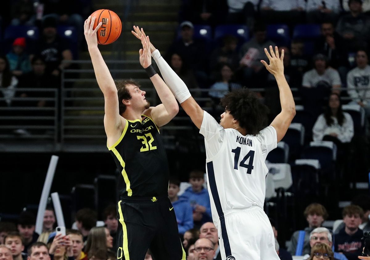 Jan 12, 2025; University Park, Pennsylvania, USA; Oregon Ducks center Nate Bittle (32) shoots the ball as Penn State Nittany Lions forward Yanic Konan Niederhauser (14) defends during the first half at Bryce Jordan Center. Mandatory Credit: Matthew O'Haren-Imagn Images