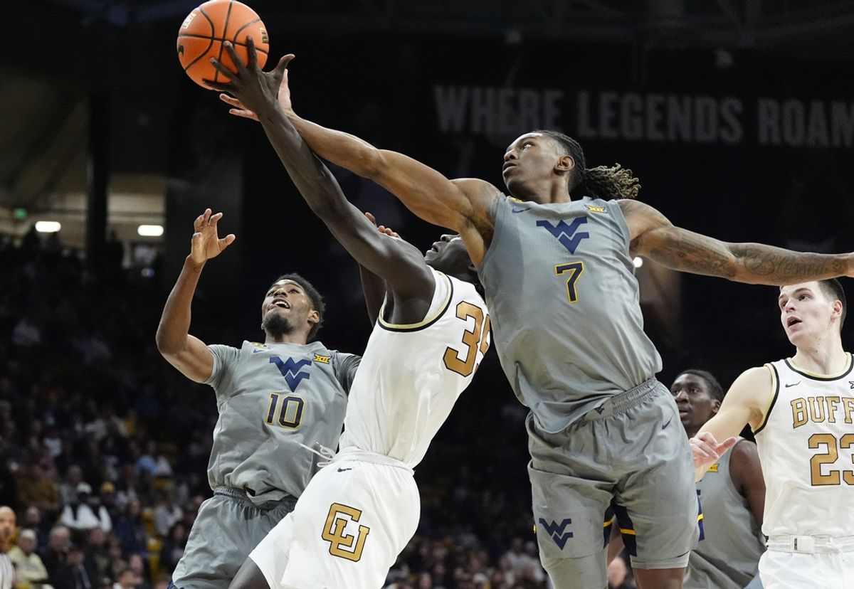 Jan 12, 2025; Boulder, Colorado, USA; West Virginia Mountaineers guard Javon Small (7) and guard Sencire Harris (10) and Colorado Buffaloes forward Assane Diop (35) reach for a rebound in the second half at CU Events Center. Mandatory Credit: Ron Chenoy-Imagn Images