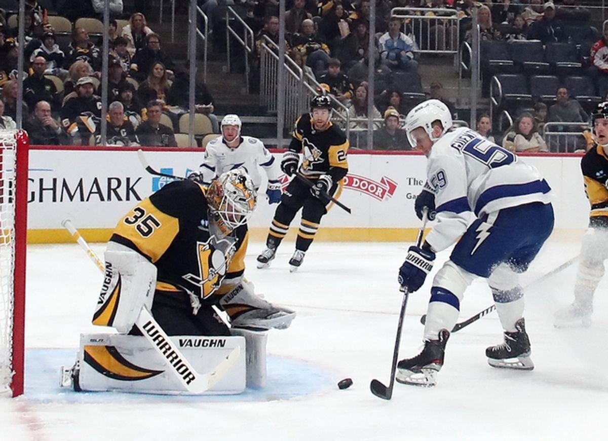 Jan 12, 2025; Pittsburgh, Pennsylvania, USA;  Pittsburgh Penguins goaltender Tristan Jarry (35) makes a save against Tampa Bay Lightning center Jake Guentzel (59) during the first period at PPG Paints Arena. Mandatory Credit: Charles LeClaire-Imagn Images