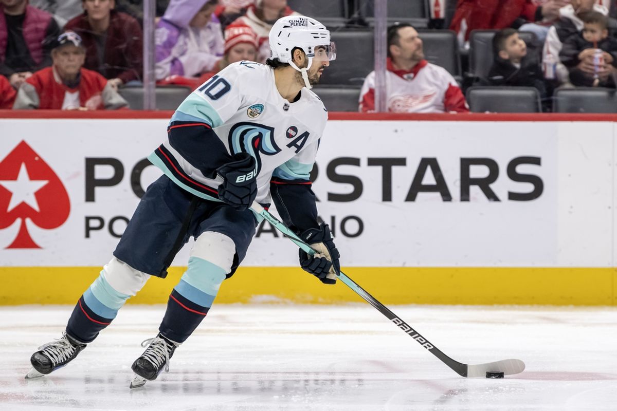 Jan 12, 2025; Detroit, Michigan, USA;  Seattle Kraken forward Matty Beniers (10) controls the puck against the Detroit Red Wings during the second period at Little Caesars Arena. Mandatory Credit: Nick Wosika-Imagn Images