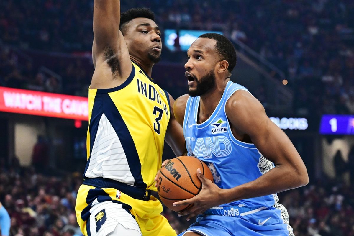 Jan 12, 2025; Cleveland, Ohio, USA; Cleveland Cavaliers forward Evan Mobley (4) drives to the basket against Indiana Pacers center Thomas Bryant (3) during the first half at Rocket Mortgage FieldHouse. Mandatory Credit: Ken Blaze-Imagn Images