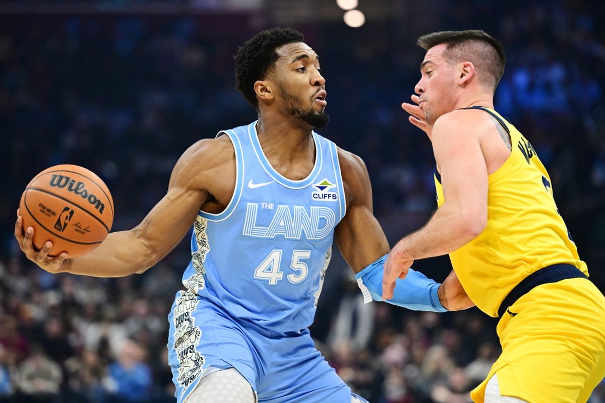 Jan 12, 2025; Cleveland, Ohio, USA; Cleveland Cavaliers guard Donovan Mitchell (45) drives to the basket against Indiana Pacers guard T.J. McConnell (9) during the first half at Rocket Mortgage FieldHouse. Mandatory Credit: Ken Blaze-Imagn Images
