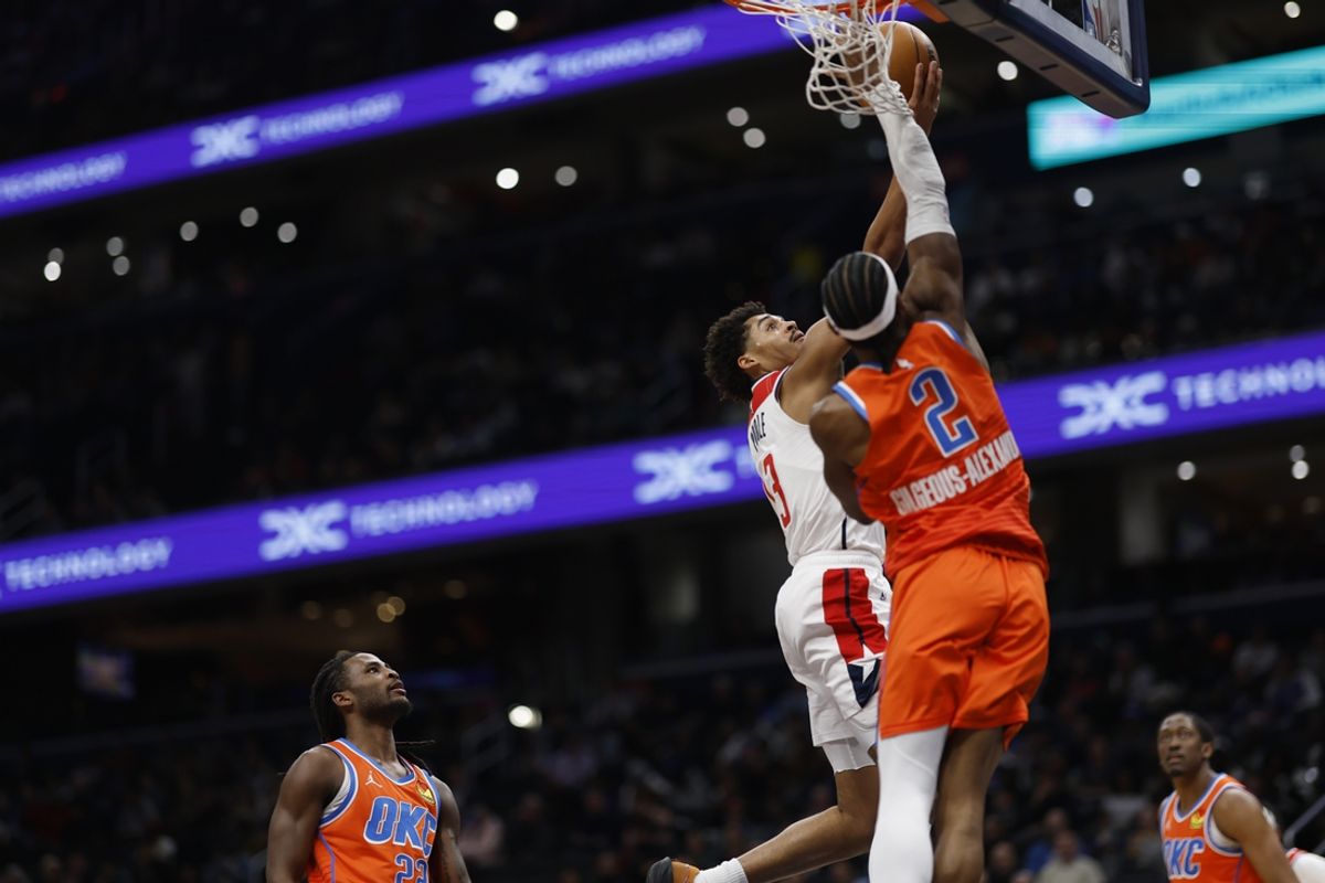 Jan 12, 2025; Washington, District of Columbia, USA; Washington Wizards guard Jordan Poole (13) is fouled by Oklahoma City Thunder guard Shai Gilgeous-Alexander (2) while shooting the ball in the first quarter at Capital One Arena. Mandatory Credit: Geoff Burke-Imagn Images