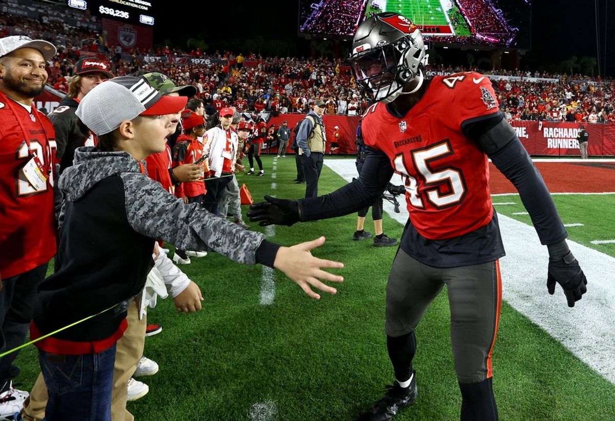 Jan 12, 2025; Tampa, Florida, USA; Tampa Bay Buccaneers linebacker Deion Jones (45) greets a fan before a NFC wild card playoff against the Washington Commanders at Raymond James Stadium. Mandatory Credit: Kim Klement Neitzel-Imagn Images