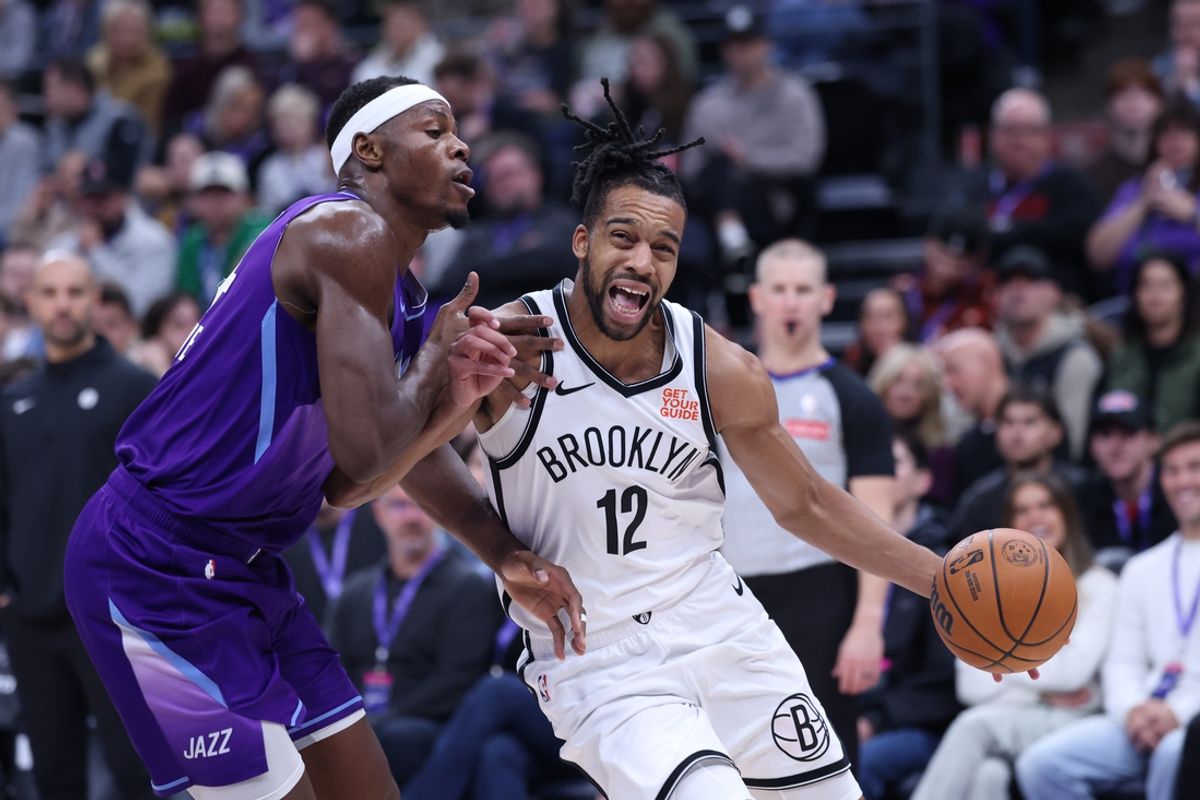 Jan 12, 2025; Salt Lake City, Utah, USA; Brooklyn Nets forward Tosan Evbuomwan (12) drives to the basket against Utah Jazz center Oscar Tshiebwe (34) during the second quarter at Delta Center. Mandatory Credit: Rob Gray-Imagn Images