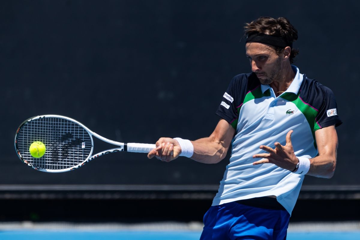 Jan 13, 2025; Melbourne, Victoria, Australia; Arthur Rinderknech of France hits a forehand during his match against Frances Tiafoe of United States of America in the first round of the men's singles at the 2025 Australian Open at Melbourne Park. Mandatory Credit: Mike Frey-Imagn Images