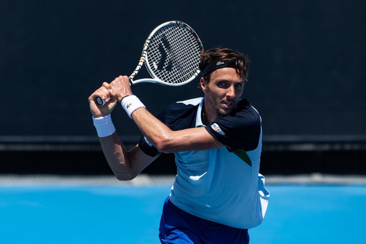 Jan 13, 2025; Melbourne, Victoria, Australia; Arthur Rinderknech of France plays a backhand during his match against Frances Tiafoe of United States of America in the first round of the men's singles at the 2025 Australian Open at Melbourne Park. Mandatory Credit: Mike Frey-Imagn Images