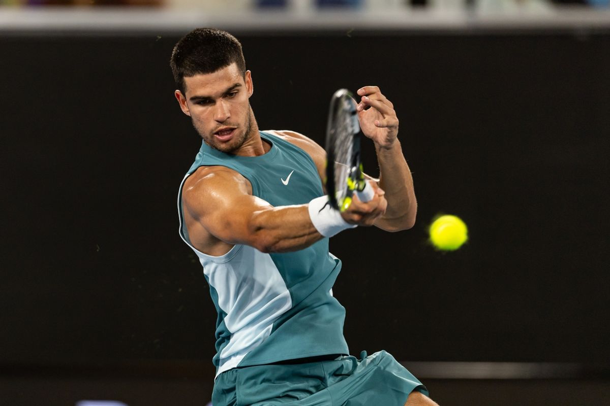 Jan 13, 2025; Melbourne, Victoria, Australia; Carlos Alcaraz of Spain hits a forehand during his match against Alexander Shevchenko of Kazakhstan in the first round of the men's singles at the 2025 Australian Open at Melbourne Park. Mandatory Credit: Mike Frey-Imagn Images
