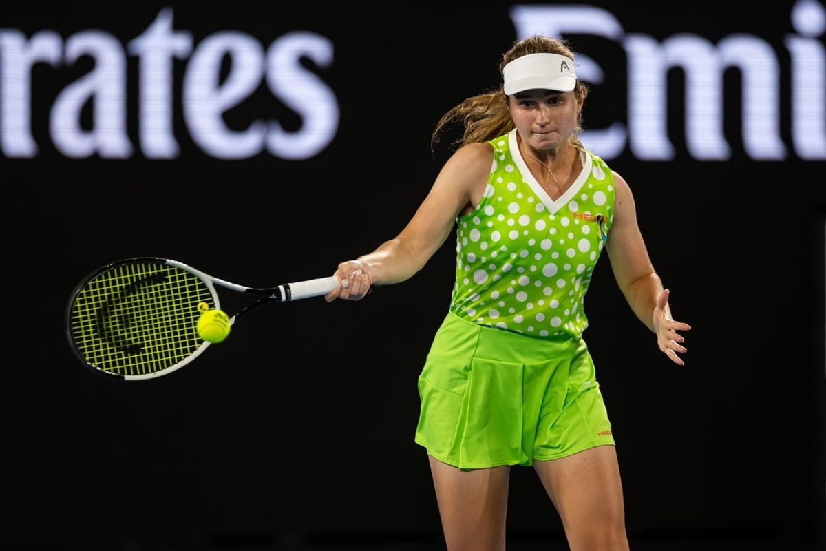 Jan 13, 2025; Melbourne, Victoria, Australia; Daria Snigur of Ukraine hits a forehand during her match against  Danielle Collins of United States of America in the first round of the men's singles at the 2025 Australian Open at Melbourne Park. Mandatory Credit: Mike Frey-Imagn Images