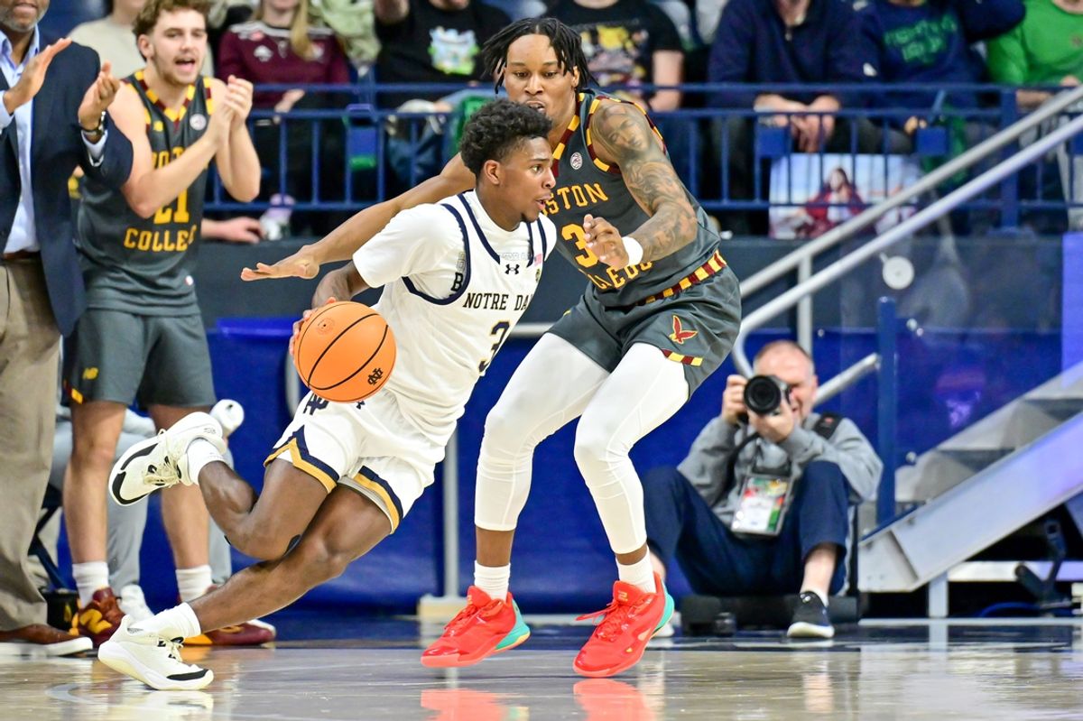 Jan 13, 2025; South Bend, Indiana, USA; Notre Dame Fighting Irish guard Markus Burton (3) dribbles as Boston College Eagles guard Roger McFarlane (3) defends in the first half at the Purcell Pavilion. Mandatory Credit: Matt Cashore-Imagn Images