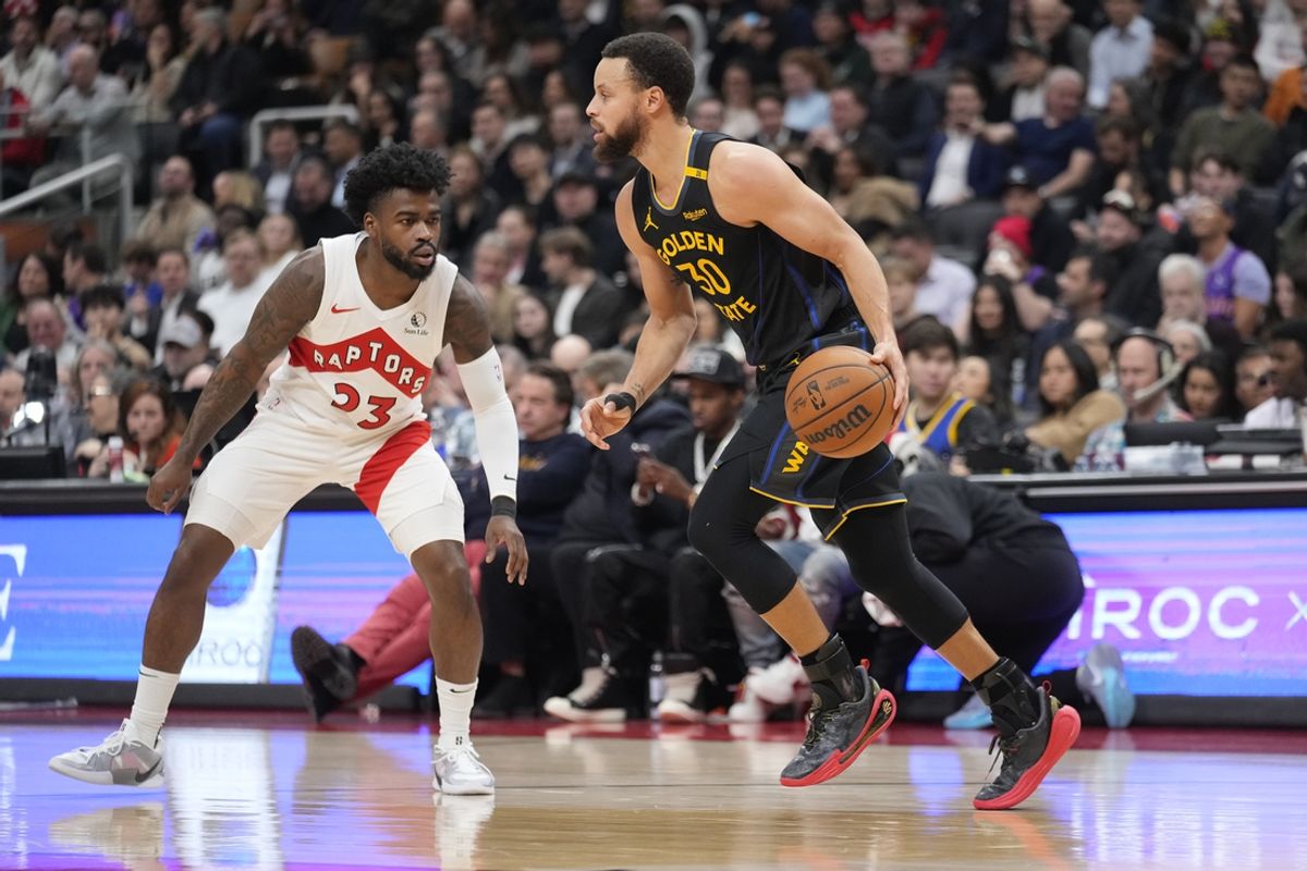Jan 13, 2025; Toronto, Ontario, CAN; Golden State Warriors guard Stephen Curry (30) dribbles the ball up court as Toronto Raptors guard Jamal Shead (23) defends during the first half at Scotiabank Arena. Mandatory Credit: John E. Sokolowski-Imagn Images