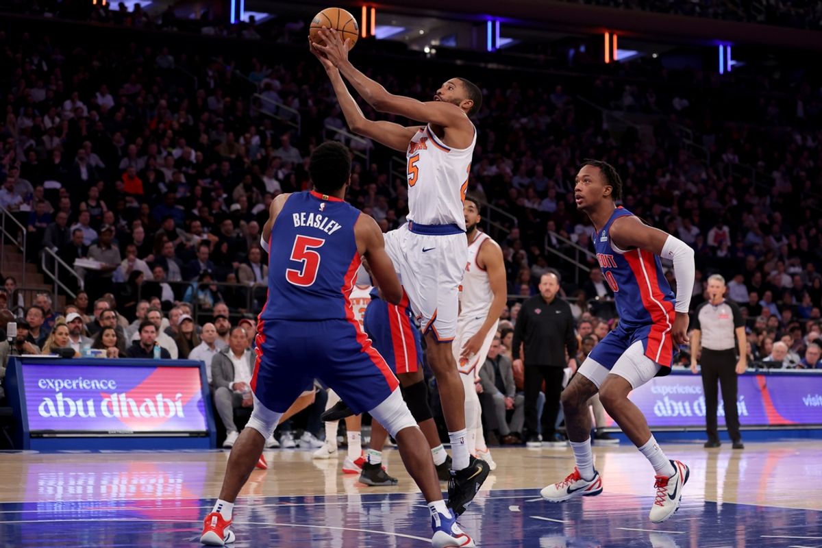 Jan 13, 2025; New York, New York, USA; New York Knicks forward Mikal Bridges (25) drives to the basket against Detroit Pistons guard Malik Beasley (5) and forward Ronald Holland II (00) during the second quarter at Madison Square Garden. Mandatory Credit: Brad Penner-Imagn Images