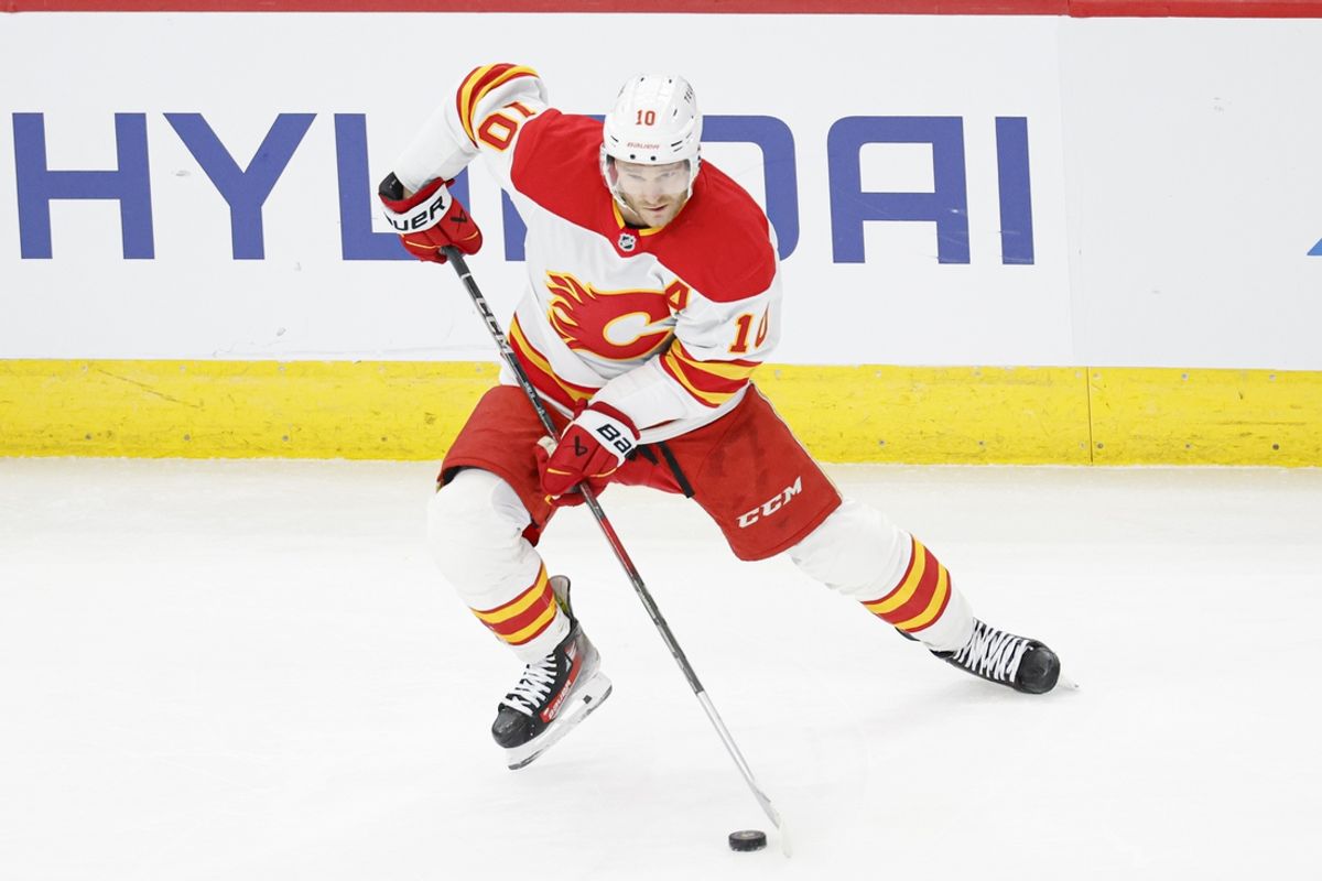 Jan 13, 2025; Chicago, Illinois, USA; Calgary Flames center Jonathan Huberdeau (10) looks to pass the puck against the Chicago Blackhawks during the second period at United Center. Mandatory Credit: Kamil Krzaczynski-Imagn Images