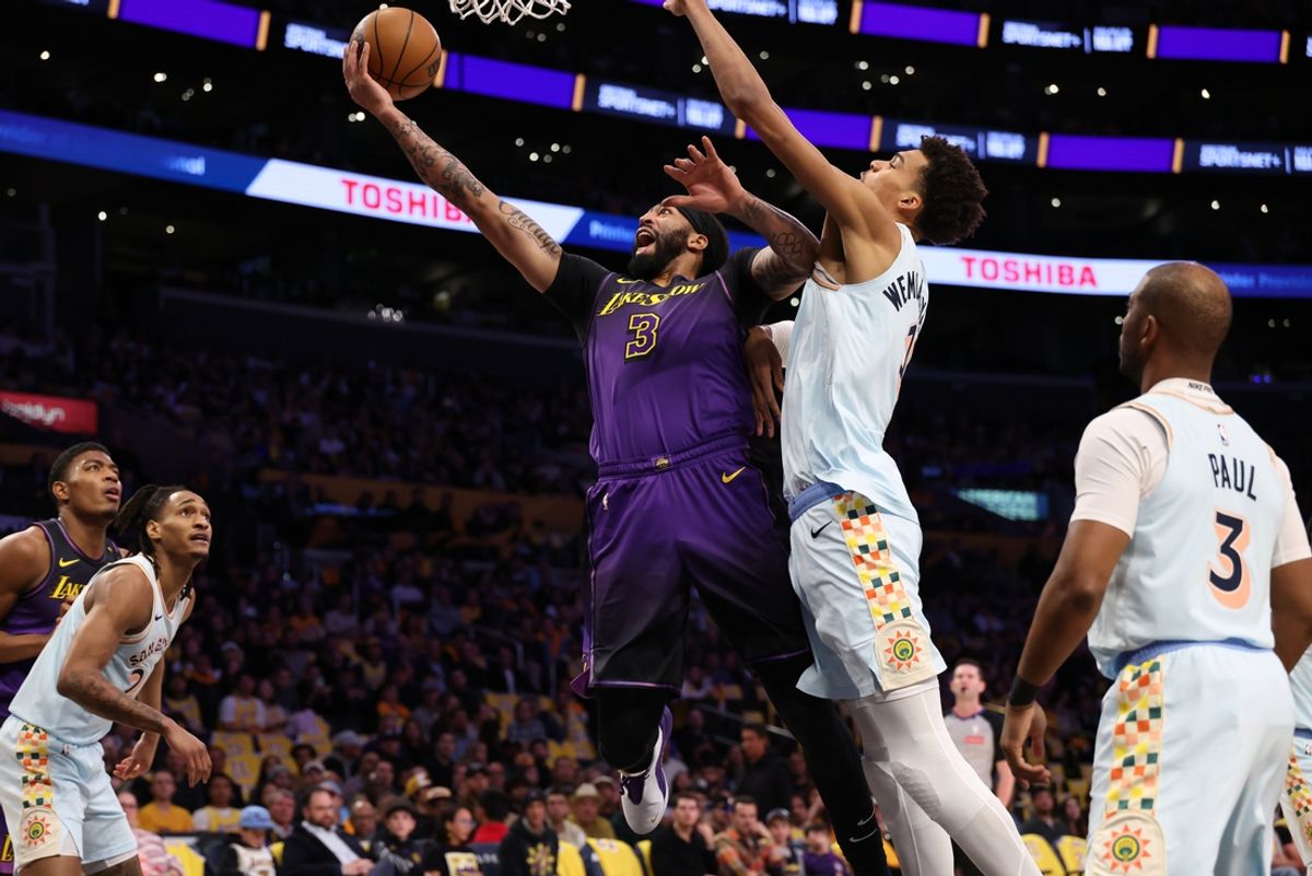 Jan 13, 2025; Los Angeles, California, USA;  Los Angeles Lakers forward Anthony Davis (3) goes to the basket against San Antonio Spurs center Victor Wembanyama (1) during the first quarter at Crypto.com Arena. Mandatory Credit: Kiyoshi Mio-Imagn Images