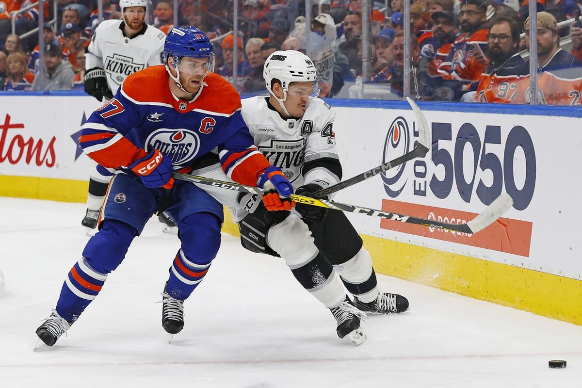 Jan 13, 2025; Edmonton, Alberta, CAN; Edmonton Oilers forward Connor McDavid (97) and Los Angeles Kings defensemen Mikey Anderson (44) battle along the boards for a loose puck during the first period at Rogers Place. Mandatory Credit: Perry Nelson-Imagn Images