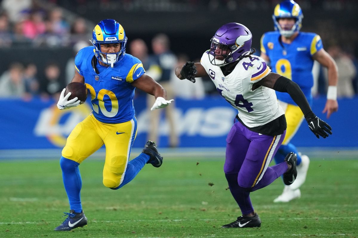 Jan 13, 2025; Glendale, AZ, USA; Los Angeles Rams running back Ronnie Rivers (20) rushes the ball against Minnesota Vikings safety Josh Metellus (44) during the second half in an NFC wild card game at State Farm Stadium. Mandatory Credit: Joe Camporeale-Imagn Images