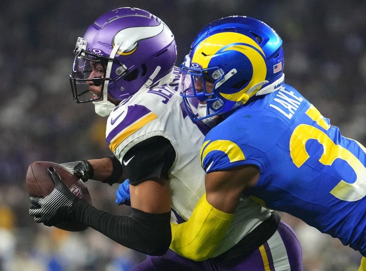 Los Angeles Rams safety Quentin Lake (37) tackles Minnesota Vikings receiver Justin Jefferson (18) during their playoff game at State Farm Stadium on Jan. 13, 2025, in Glendale.