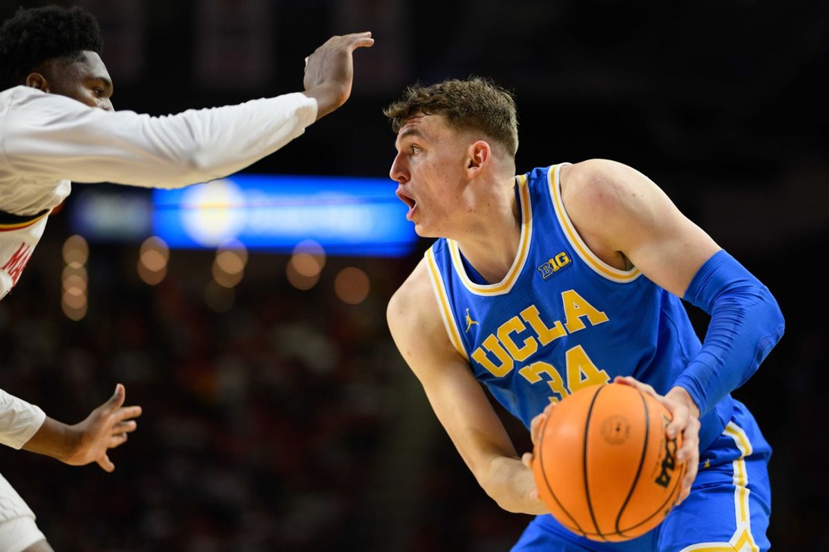 Jan 10, 2025; College Park, Maryland, USA; UCLA Bruins forward Tyler Bilodeau (34) handles the ball against Maryland Terrapins center Derik Queen (25) during the first half at Xfinity Center. Mandatory Credit: Reggie Hildred-Imagn Images
