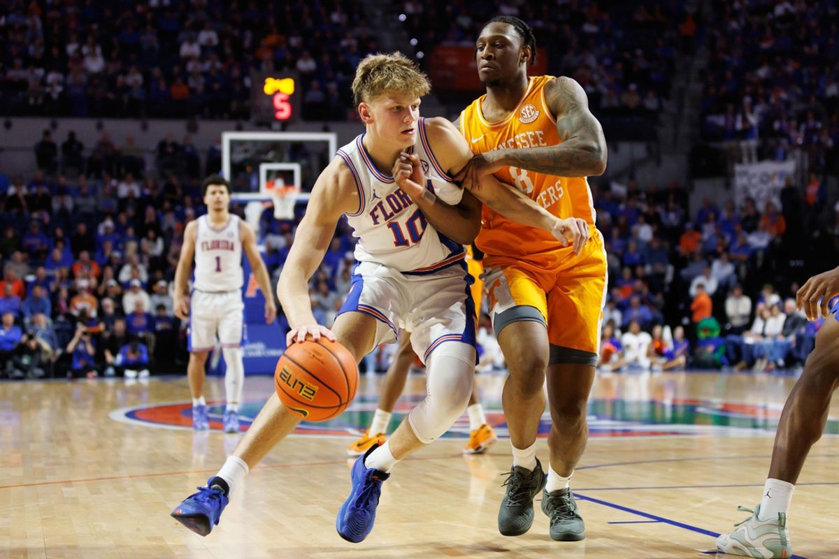 Jan 7, 2025; Gainesville, Florida, USA; Florida Gators forward Thomas Haugh (10) drives to the basket past Tennessee Volunteers guard Darlinstone Dubar (8) during the second half at Exactech Arena at the Stephen C. O'Connell Center. Mandatory Credit: Matt Pendleton-Imagn Images