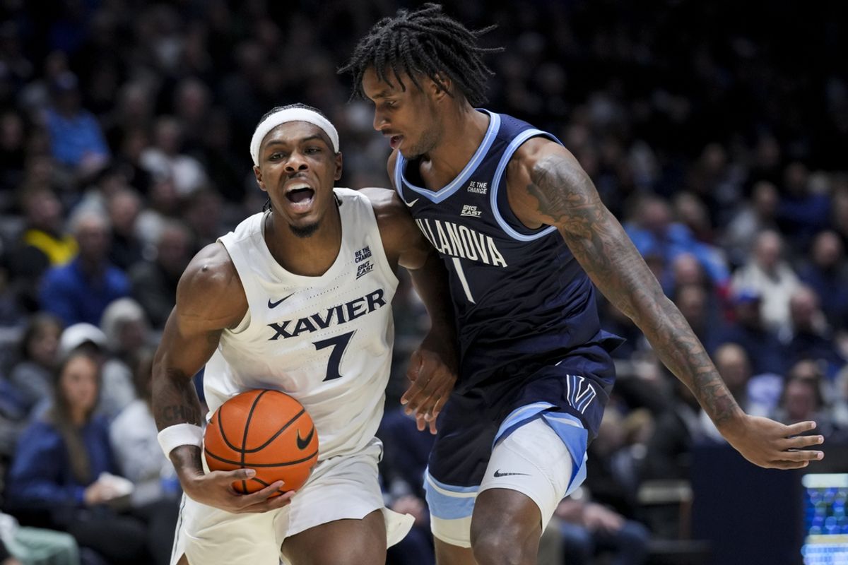 Jan 14, 2025; Cincinnati, Ohio, USA;  Xavier Musketeers guard Ryan Conwell (7) reacts as he drives to the basket against Villanova Wildcats guard Kris Parker (1) in the first half at the Cintas Center. Mandatory Credit: Aaron Doster-Imagn Images