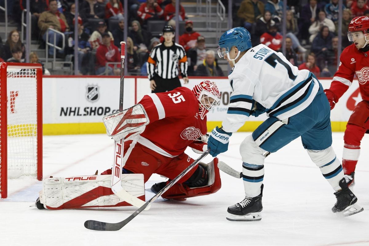 Jan 14, 2025; Detroit, Michigan, USA;  San Jose Sharks center Nico Sturm (7) scores against Detroit Red Wings goaltender Ville Husso (35) in the first period at Little Caesars Arena. Mandatory Credit: Rick Osentoski-Imagn Images