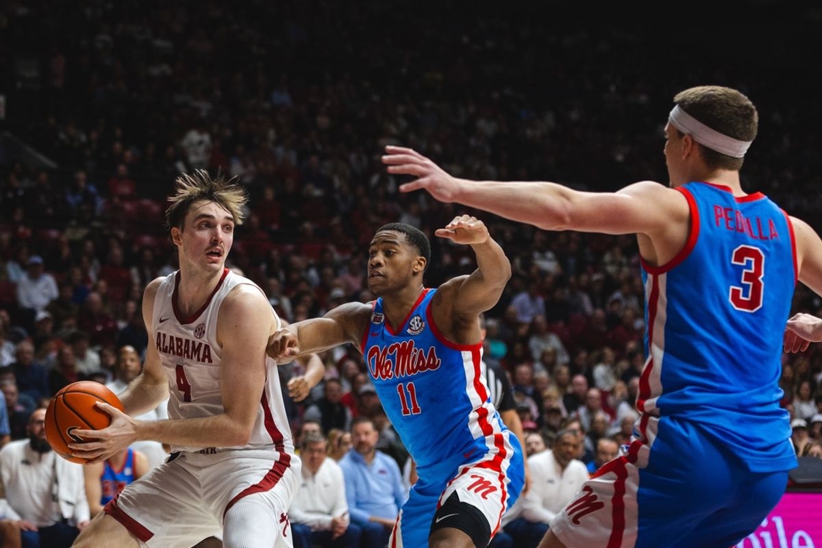 Jan 14, 2025; Tuscaloosa, Alabama, USA; Alabama Crimson Tide forward Grant Nelson (4) works against Mississippi Rebels guard Matthew Murrell (11) and guard Sean Pedulla (3) during the first half at Coleman Coliseum. Mandatory Credit: Will McLelland-Imagn Images