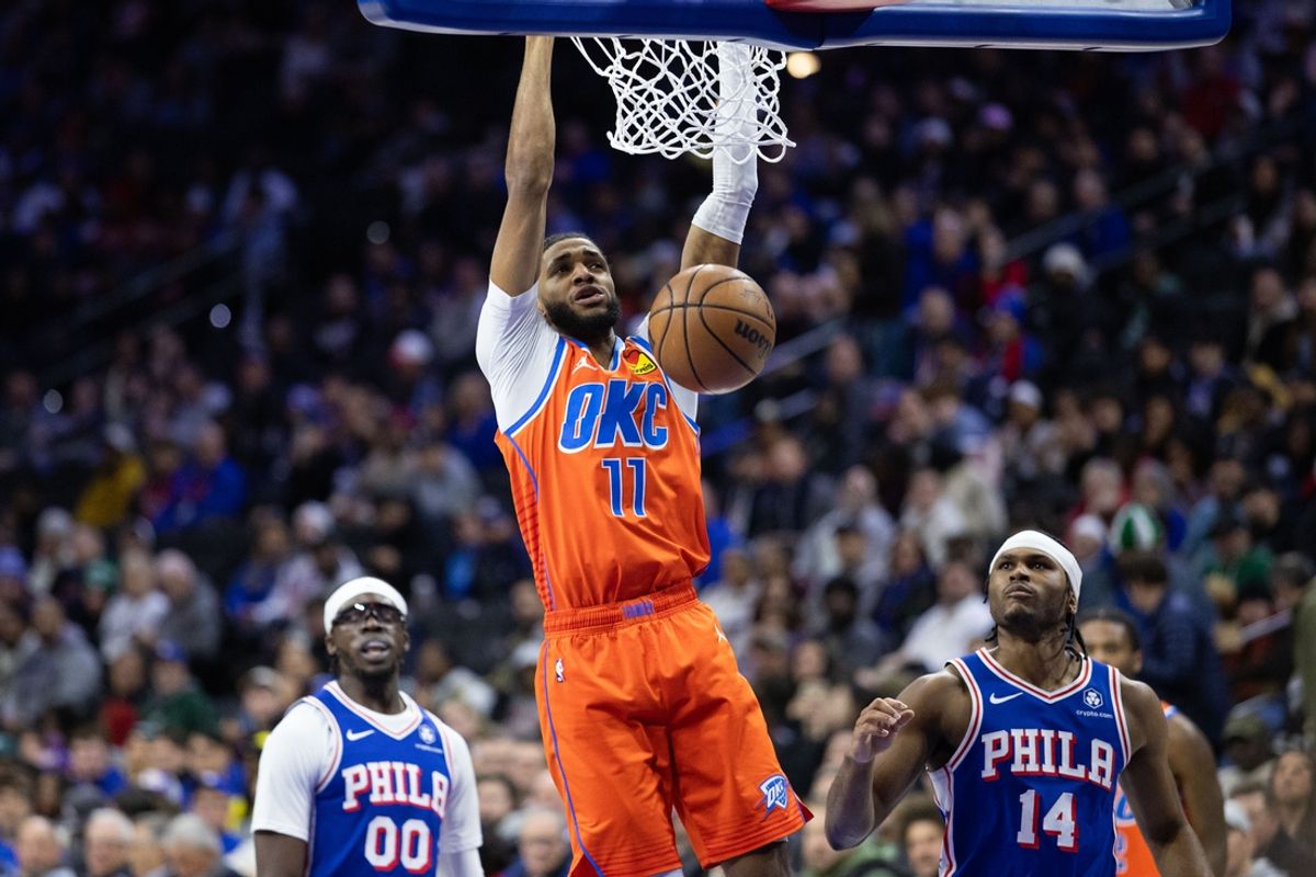 Jan 14, 2025; Philadelphia, Pennsylvania, USA; Oklahoma City Thunder guard Isaiah Joe (11) dunks in front of Philadelphia 76ers guard Ricky Council IV (14) during the second quarter at Wells Fargo Center. Mandatory Credit: Bill Streicher-Imagn Images