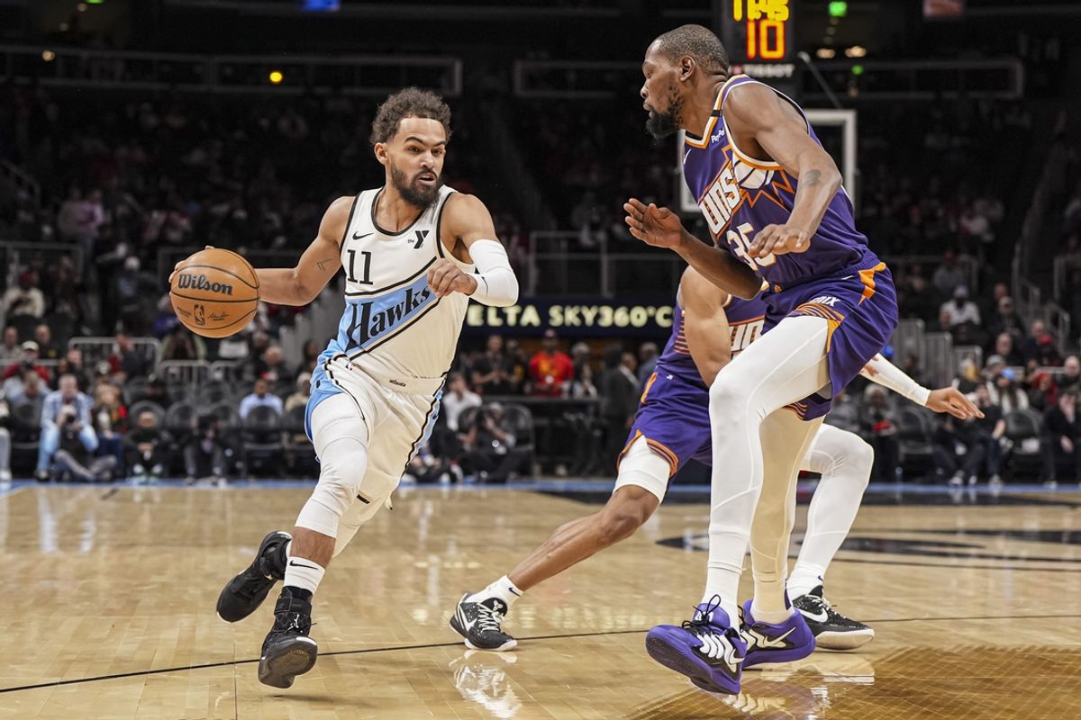Jan 14, 2025; Atlanta, Georgia, USA; Atlanta Hawks guard Trae Young (11) dribbles against Phoenix Suns forward Kevin Durant (35) during the first half at State Farm Arena. Mandatory Credit: Dale Zanine-Imagn Images