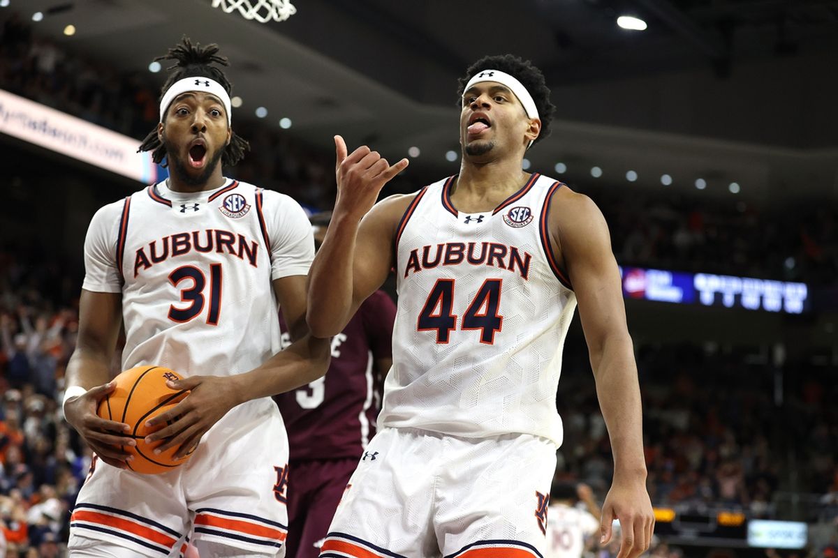 Jan 14, 2025; Auburn, Alabama, USA;  Auburn Tigers forward Chaney Johnson (31) reacts to a dunk by center Dylan Cardwell (44) in during the second half against the Mississippi State Bulldogs at Neville Arena. Mandatory Credit: John Reed-Imagn Images