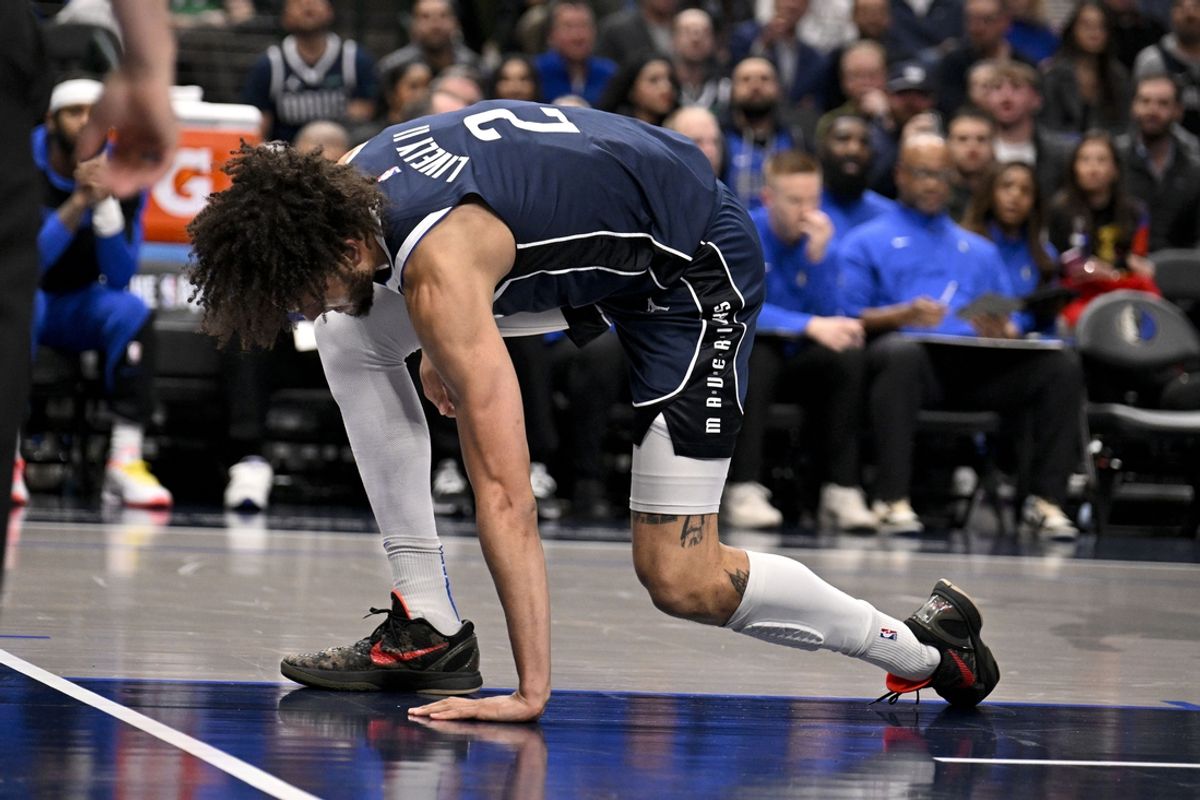 Jan 14, 2025; Dallas, Texas, USA; Dallas Mavericks center Dereck Lively II (2) reacts after suffering a possible leg injury during the first quarter against the Denver Nuggets at the American Airlines Center. Mandatory Credit: Jerome Miron-Imagn Images