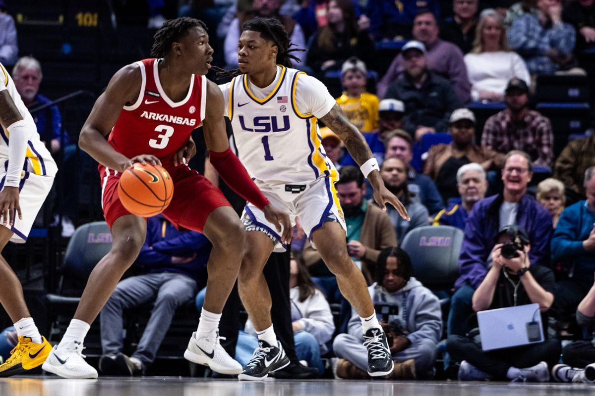 Jan 14, 2025; Baton Rouge, Louisiana, USA;  Arkansas Razorbacks forward Adou Thiero (3) dribbles against LSU Tigers guard Jordan Sears (1) during the first half at Pete Maravich Assembly Center. Mandatory Credit: Stephen Lew-Imagn Images