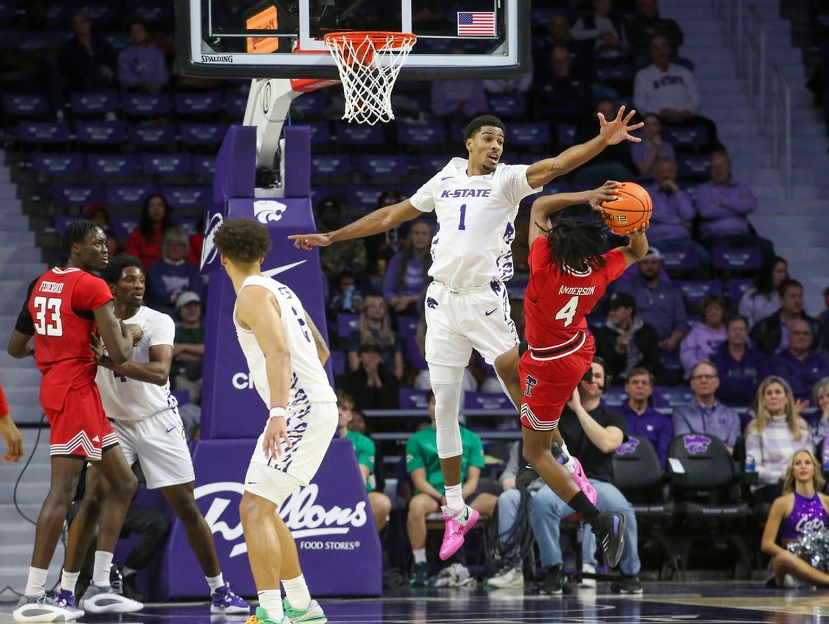 Jan 14, 2025; Manhattan, Kansas, USA; Texas Tech Red Raiders guard Christian Anderson (4) tries to shoot over Kansas State Wildcats forward David N'Guessan (1) during the first half at Bramlage Coliseum. Mandatory Credit: Scott Sewell-Imagn Images