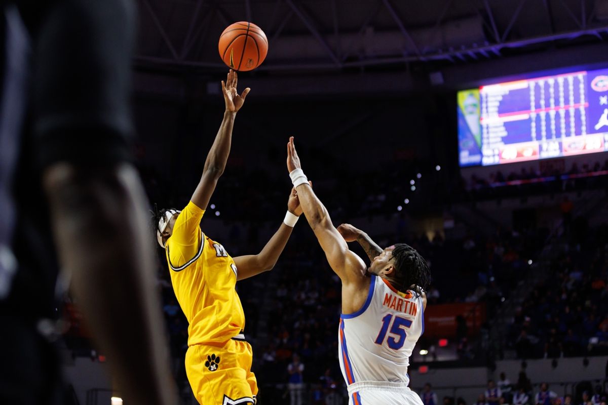 Jan 14, 2025; Gainesville, Florida, USA; Missouri Tigers guard Anthony Robinson II (0) shoots over Florida Gators guard Alijah Martin (15) during the first half at Exactech Arena at the Stephen C. O'Connell Center. Mandatory Credit: Matt Pendleton-Imagn Images