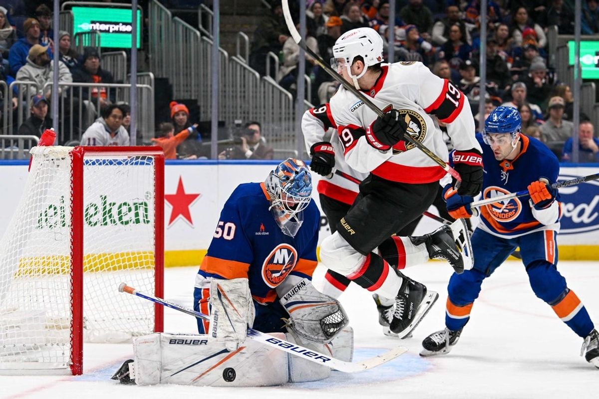 Jan 14, 2025; Elmont, New York, USA;  Ottawa Senators right wing Drake Batherson (19) jumps over a shot saved by New York Islanders goaltender Marcus Hogberg (50) during the third period at UBS Arena. Mandatory Credit: Dennis Schneidler-Imagn Images