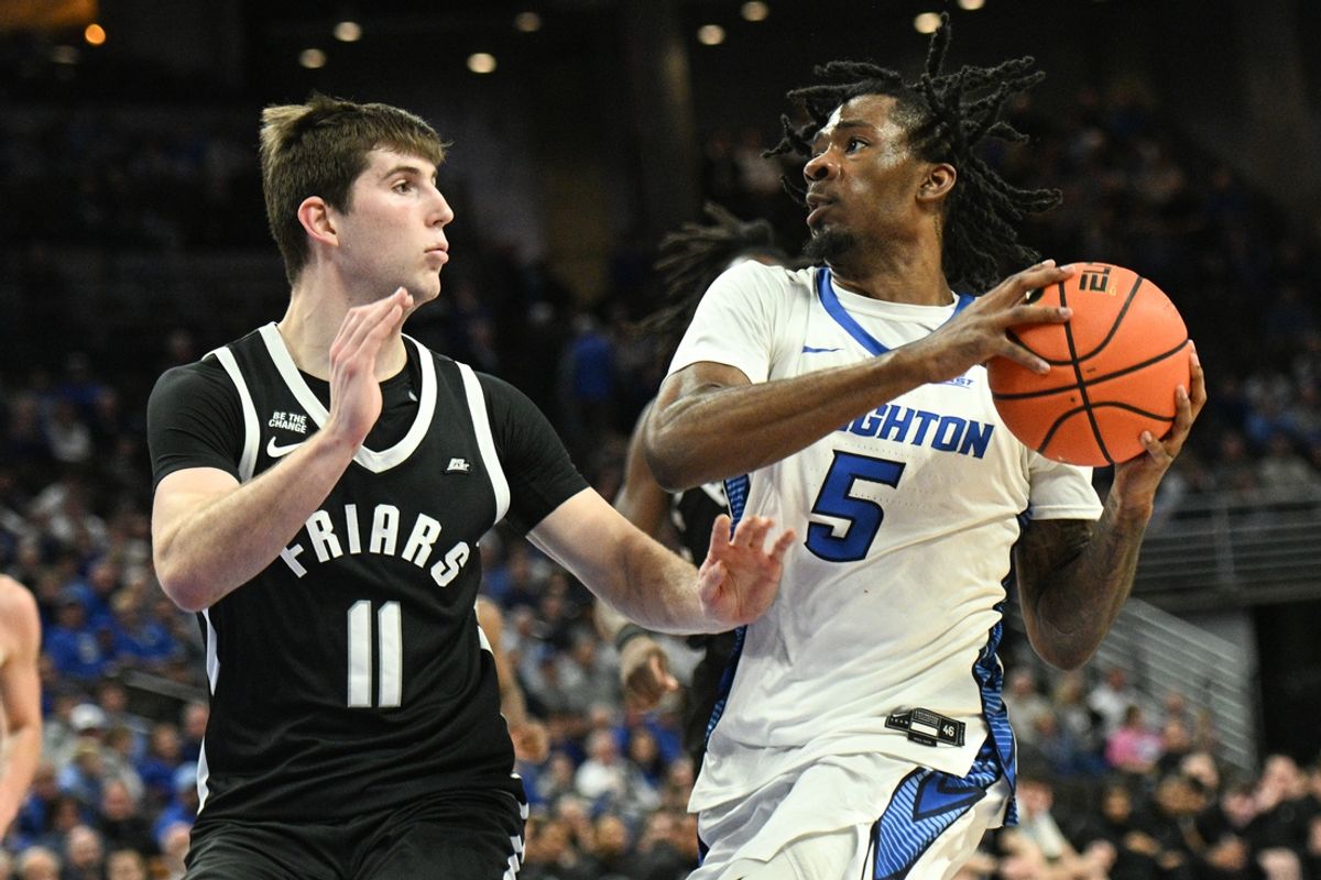 Jan 14, 2025; Omaha, Nebraska, USA;  Creighton Bluejays guard Jamiya Neal (5) drives against Providence Friars forward Ryan Mela (11) during the second half at CHI Health Center Omaha. Mandatory Credit: Steven Branscombe-Imagn Images