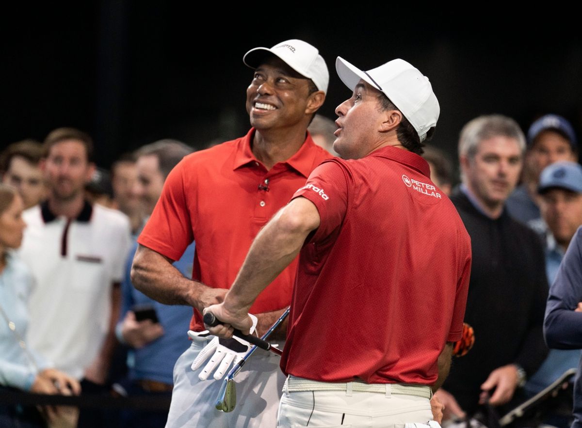 Golfers Tiger Woods and Kevin Kisner warm up at SoFi Center before the golf match between Jupiter Links and Los Angeles Golf Club in the TGL, interactive golf league founded by Woods and Rory McIlroy on January 14, 2025 in Palm Beach Gardens, Florida.