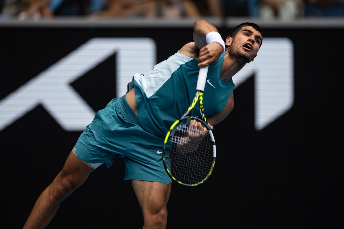 Jan 15, 2025; Melbourne, Victoria, Australia; Carlos Alcaraz of Spain serves during his match against Yoshihito Nishioka of Japan in the second round of the men's singles at the 2025 Australian Open at Melbourne Park. Mandatory Credit: Mike Frey-Imagn Images
