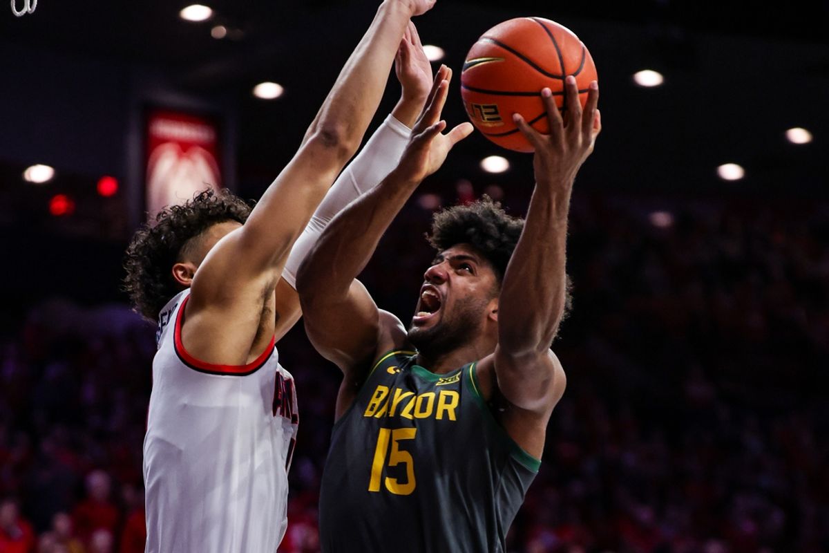Jan 14, 2025; Tucson, Arizona, USA; Baylor Bears forward Norchad Omier (15) goes for a lay up while Arizona Wildcats forward Trey Townsend (4) attempts to block him during the first half of the game at McKale Center. Mandatory Credit: Aryanna Frank-Imagn Images