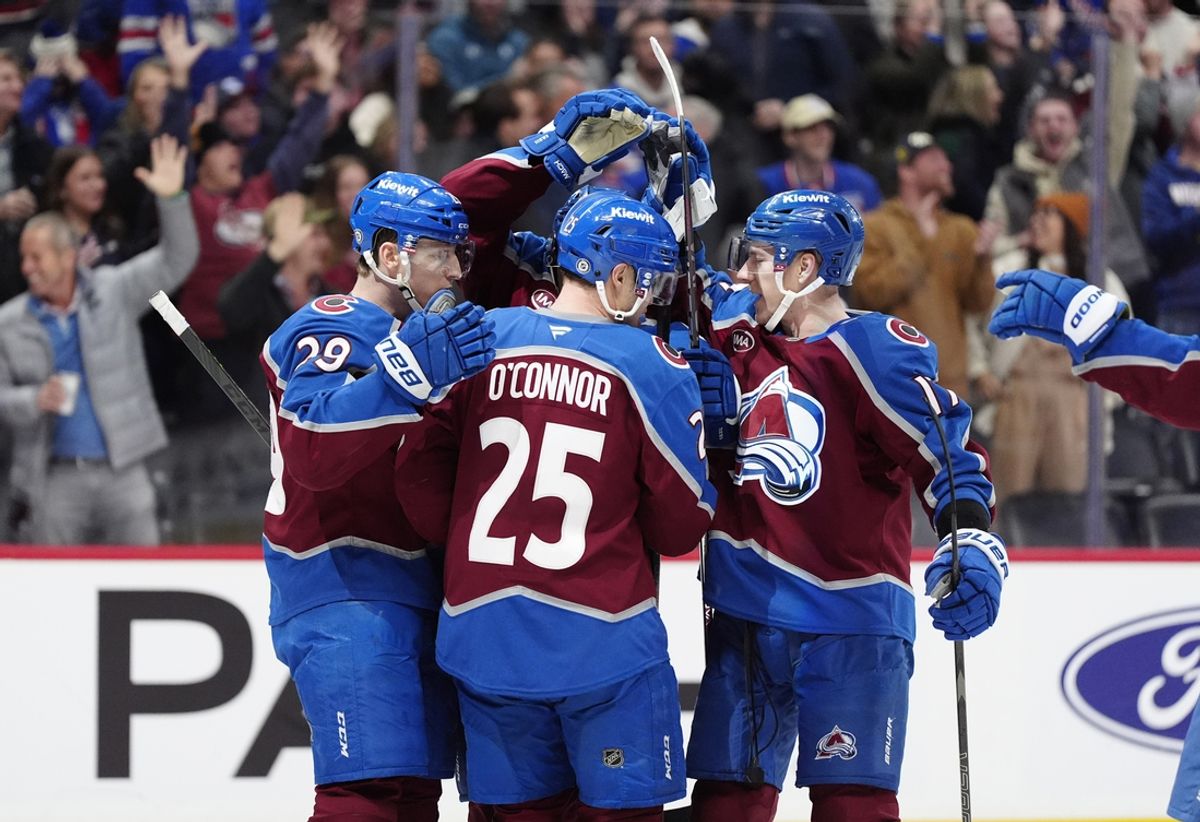 Jan 14, 2025; Denver, Colorado, USA; Members of the Colorado Avalanche celebrate a overtime win against the New York Rangers at Ball Arena. Mandatory Credit: Ron Chenoy-Imagn Images