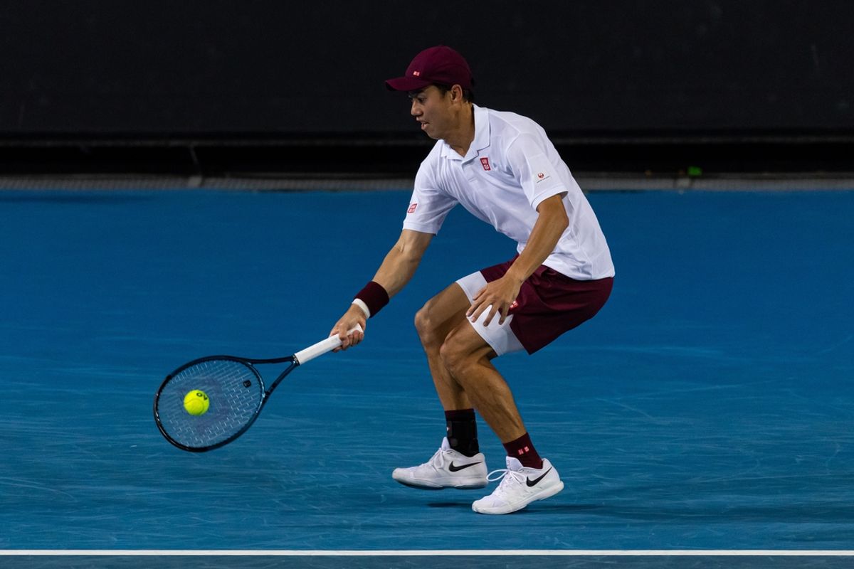 Jan 15, 2025; Melbourne, Victoria, Australia; Kei Nishikori of Japan hits a forehand during his match against Tommy Paul of United States of America in the second round of the men's singles at the 2025 Australian Open at Melbourne Park. Mandatory Credit: Mike Frey-Imagn Images