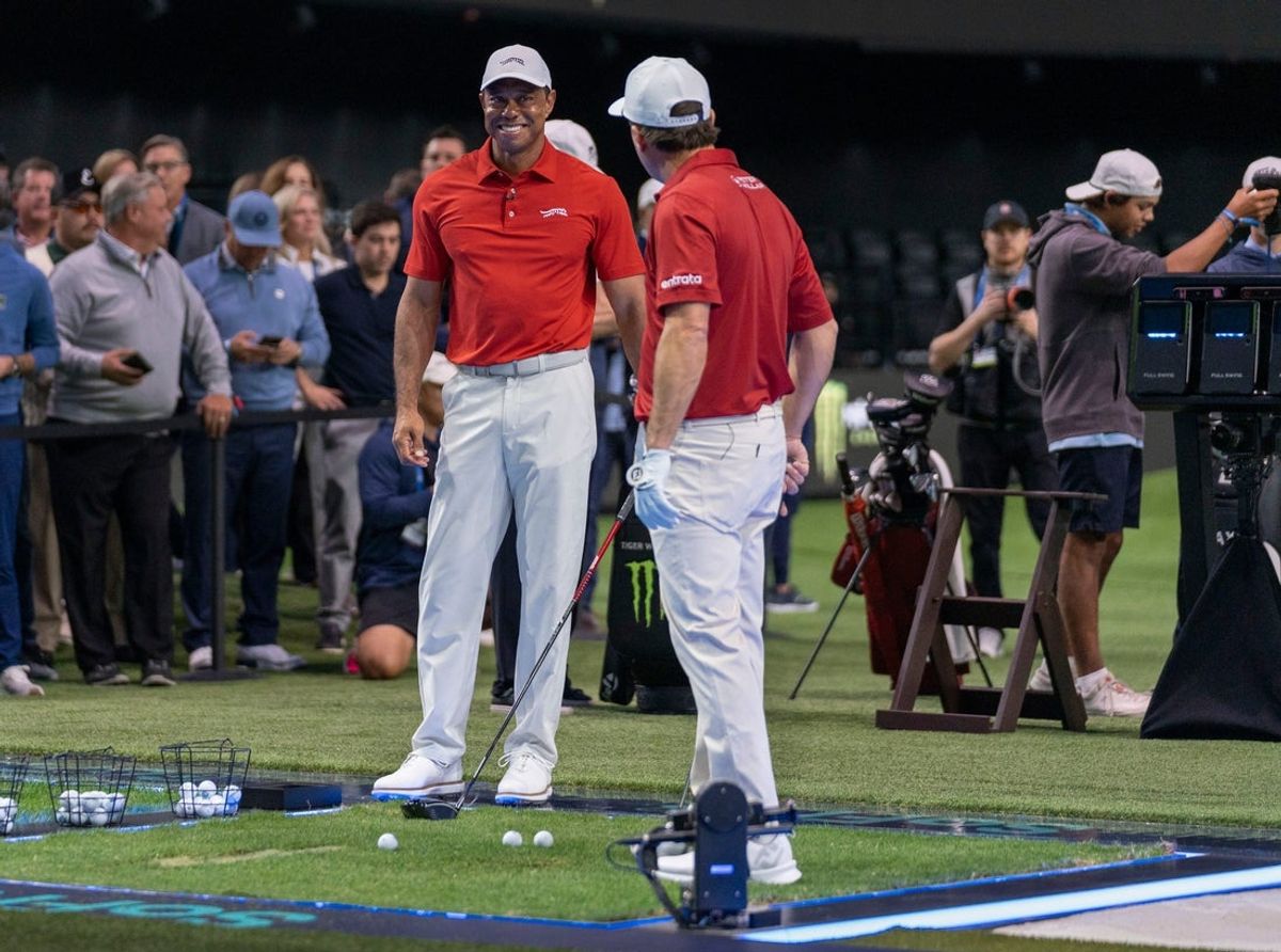 Golfers Tiger Woods and Kevin Kisner warm up at SoFi Center before the golf match between Jupiter Links and Los Angeles Golf Club in the TGL, interactive golf league founded by Woods and Rory McIlroy on January 14, 2025 in Palm Beach Gardens, Florida.