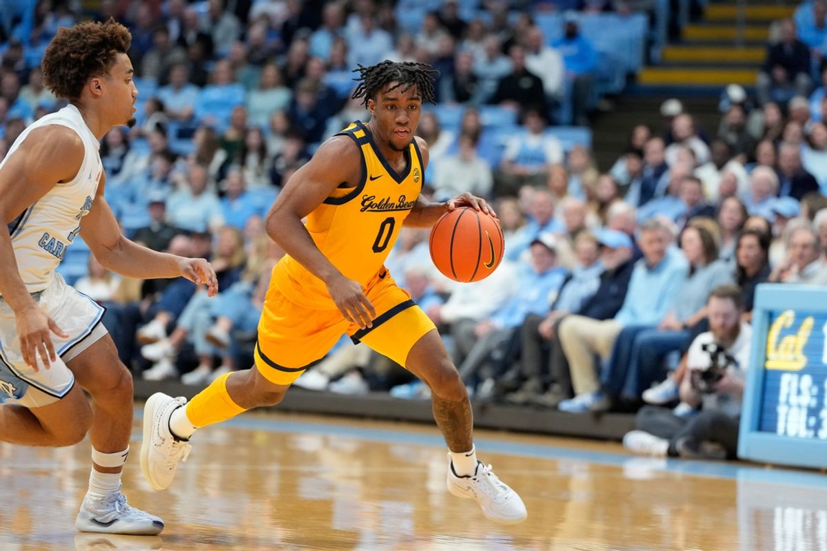 Jan 15, 2025; Chapel Hill, North Carolina, USA; California Golden Bears guard Jeremiah Wilkinson (0) with the ball as North Carolina Tar Heels guard Seth Trimble (7) defends in the first half at Dean E. Smith Center. Mandatory Credit: Bob Donnan-Imagn Images
