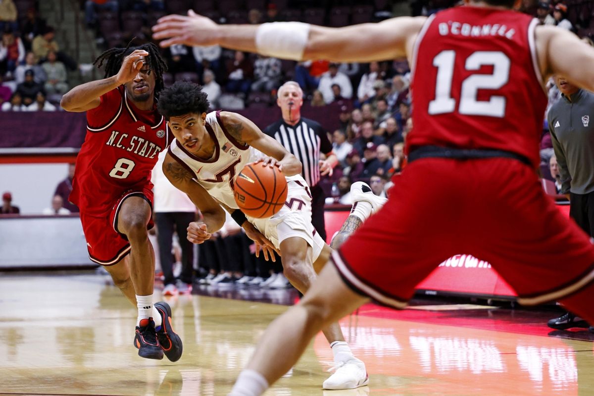 Jan 15, 2025; Blacksburg, Virginia, USA; Virginia Tech Hokies guard Rodney Brown Jr. (4) drives to the basket against North Carolina State Wolfpack guard Jayden Taylor (8) during the first half at Cassell Coliseum. Mandatory Credit: Peter Casey-Imagn Images