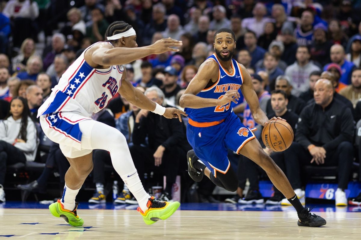 Jan 15, 2025; Philadelphia, Pennsylvania, USA; New York Knicks forward Mikal Bridges (25) dribbles the ball against Philadelphia 76ers forward Guerschon Yabusele (28) during the second quarter at Wells Fargo Center. Mandatory Credit: Bill Streicher-Imagn Images