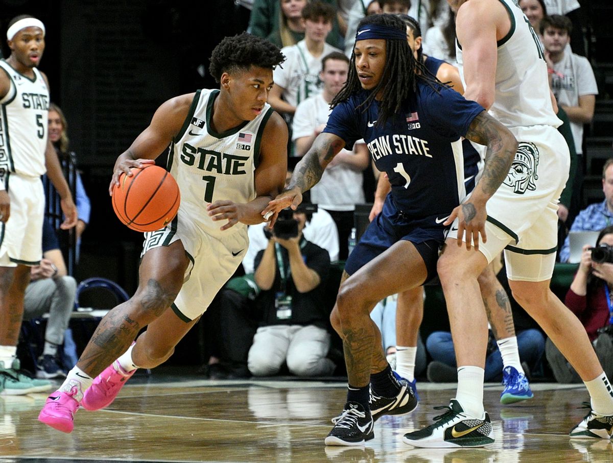 Jan 15, 2025; East Lansing, Michigan, USA;  Michigan State Spartans guard Jeremy Fears Jr. (1) drives past Penn State Nittany Lions guard Ace Baldwin Jr. (1) during the first half at Jack Breslin Student Events Center. Mandatory Credit: Dale Young-Imagn Images