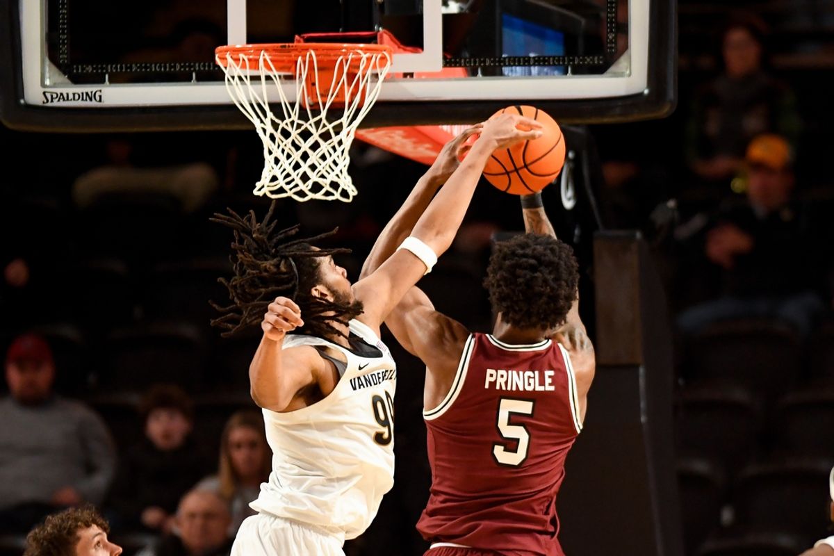 Jan 15, 2025; Nashville, Tennessee, USA;  Vanderbilt Commodores forward Devin McGlockton (99) blocks the shot of South Carolina Gamecocks forward Nick Pringle (5) during the second half at Memorial Gymnasium. Mandatory Credit: Steve Roberts-Imagn Images