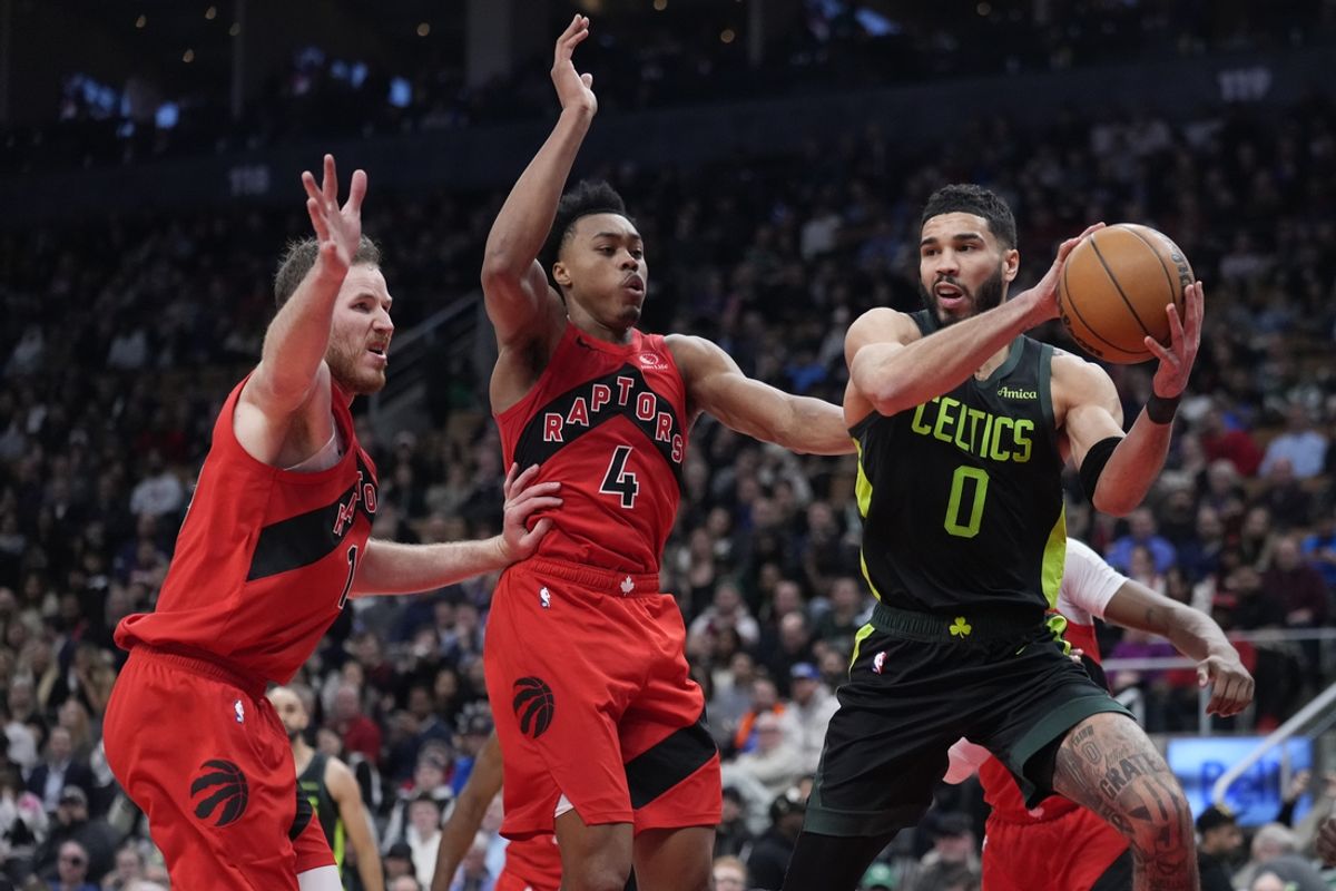 Jan 15, 2025; Toronto, Ontario, CAN; Boston Celtics forward Jayson Tatum (0) passes against Toronto Raptors forward Scottie Barnes (4) and center Jakob Poeltl (19) during the first half at Scotiabank Arena. Mandatory Credit: John E. Sokolowski-Imagn Images