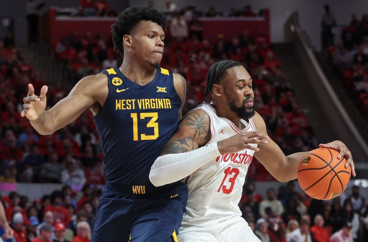 Jan 15, 2025; Houston, Texas, USA; Houston Cougars forward J'Wan Roberts (13) dribbles against West Virginia Mountaineers forward Amani Hansberry (13) in the first half at Fertitta Center. Mandatory Credit: Thomas Shea-Imagn Images