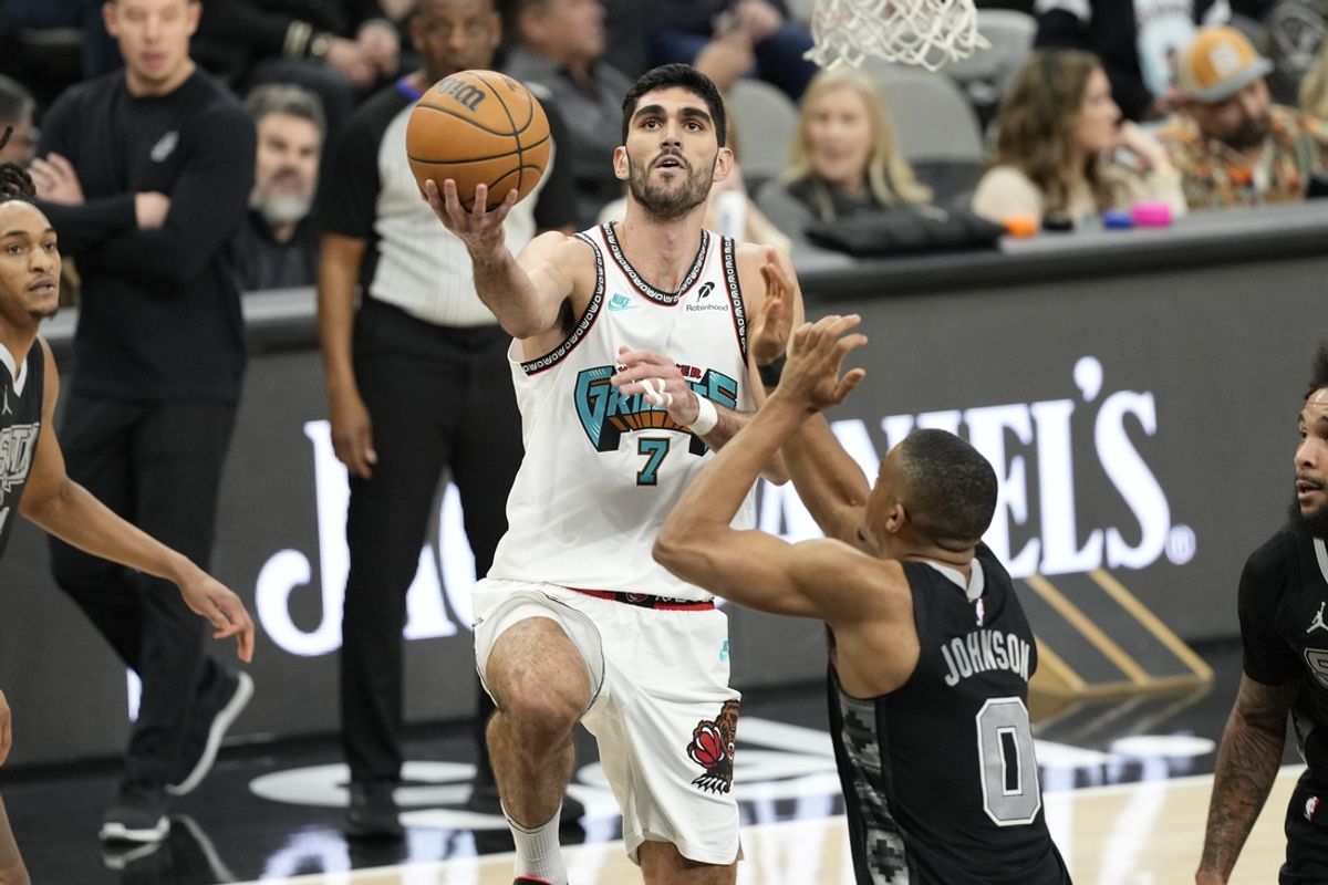 Jan 15, 2025; San Antonio, Texas, USA; mg Memphis Grizzlies forward Santi Aldama (7) drives to the basket against San Antonio Spurs forward Keldon Johnson (0) during the first half at Frost Bank Center. Mandatory Credit: Scott Wachter-Imagn Images