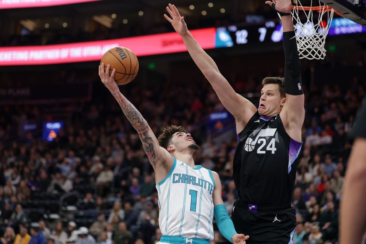 Jan 15, 2025; Salt Lake City, Utah, USA;  Charlotte Hornets guard LaMelo Ball (1) shoots against Utah Jazz center Walker Kessler (24) during the first quarter at Delta Center. Mandatory Credit: Chris Nicoll-Imagn Images